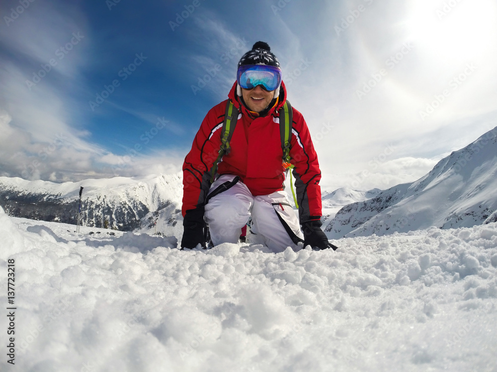 Skier with skiing equipment on mountain