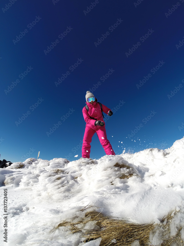 Skier in ski suit enjoying in mountain.