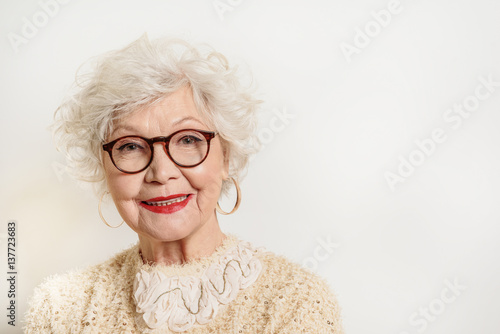 Joyful senior lady in glasses laughing