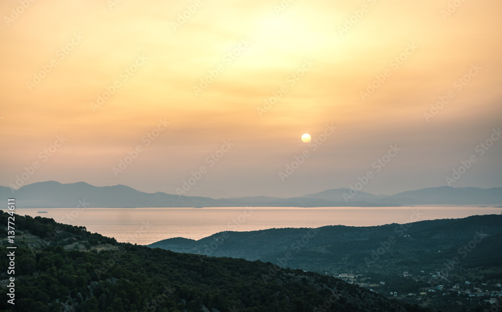 Obraz premium Sunrise view of mountains and sea on Aegina island, Greece.