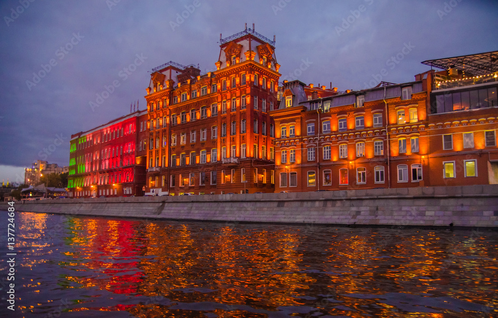 Moscow night landscape with river and red october factory.