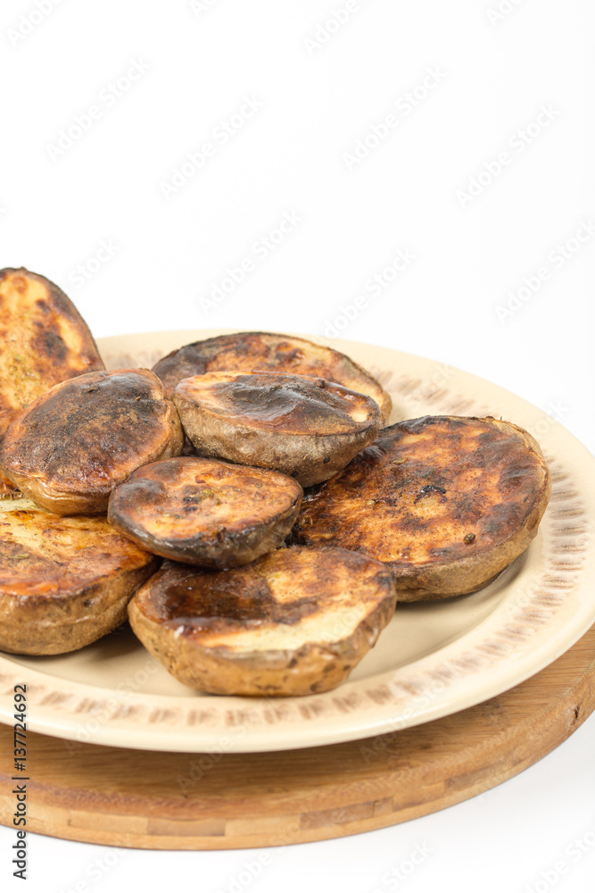 Isolated baked potatoes in the shell on the plate