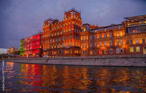 Moscow night landscape with river and red october factory.