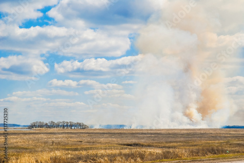Burning the steppe during the spring drought. Grassroots Prairie fire. Burns dry grass