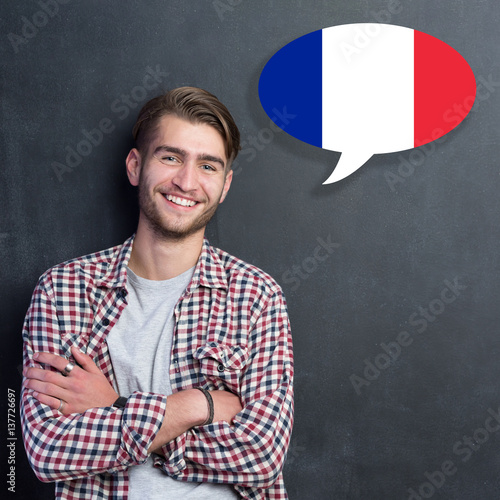 Man learn speaking french in bubble on chalkboard photo