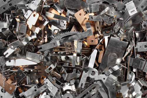 Pile of shiny metal parts. Scrap steel details as abstract industrial background.