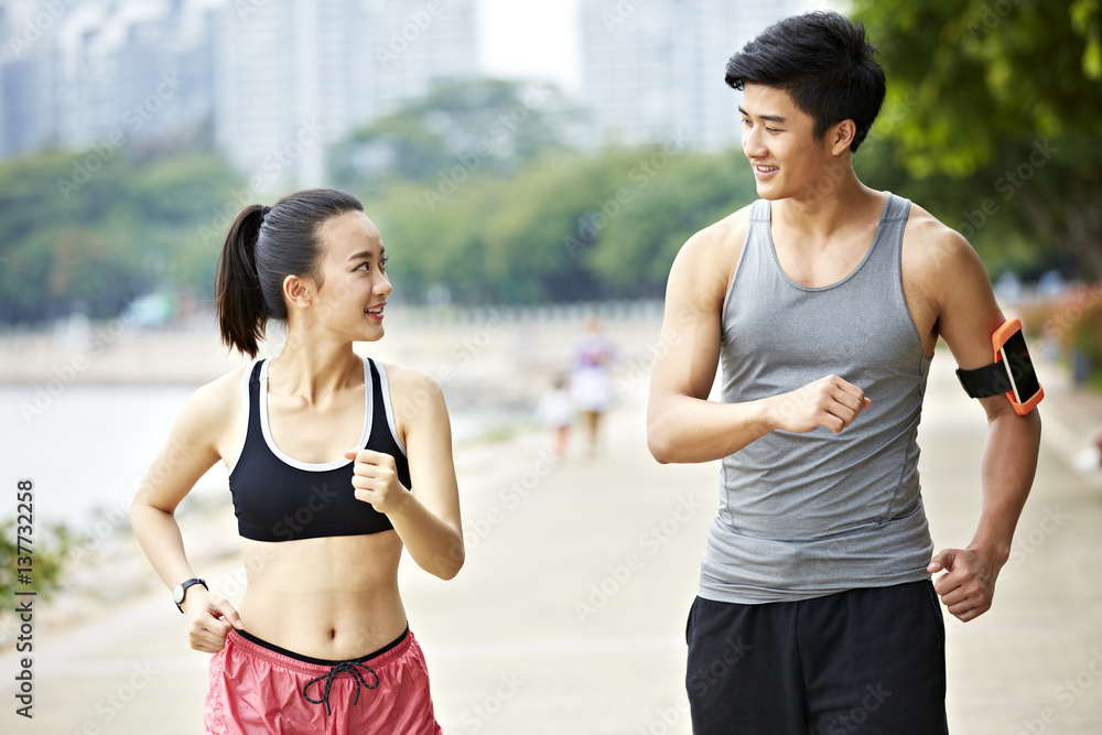 young asian couple jogging outdoors