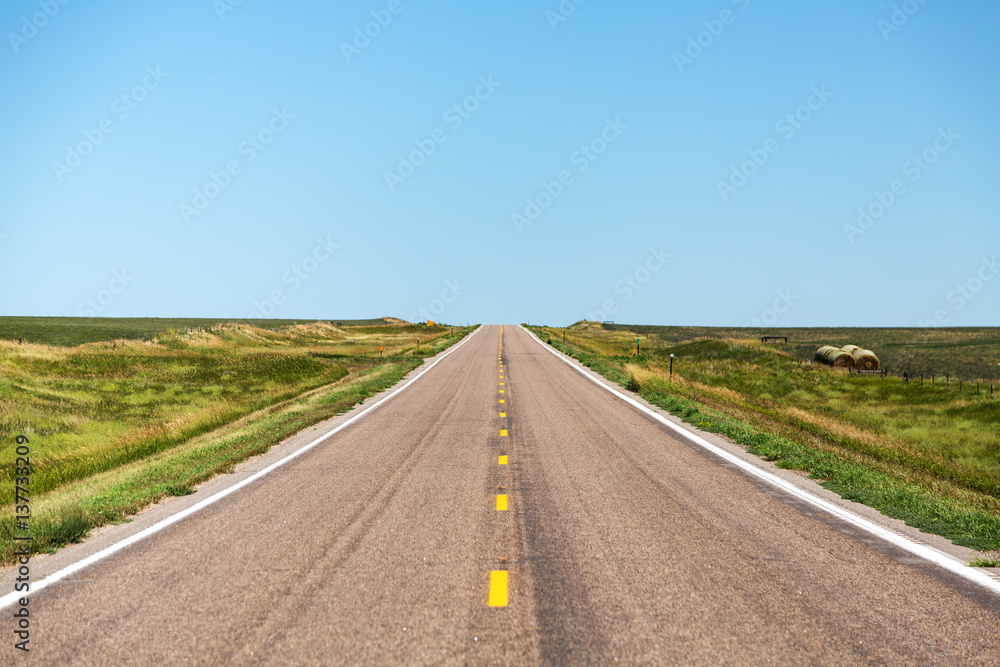 A road cutting through northern Nebraska on a summer day. A road cutting through northern Nebraska on a summer day.