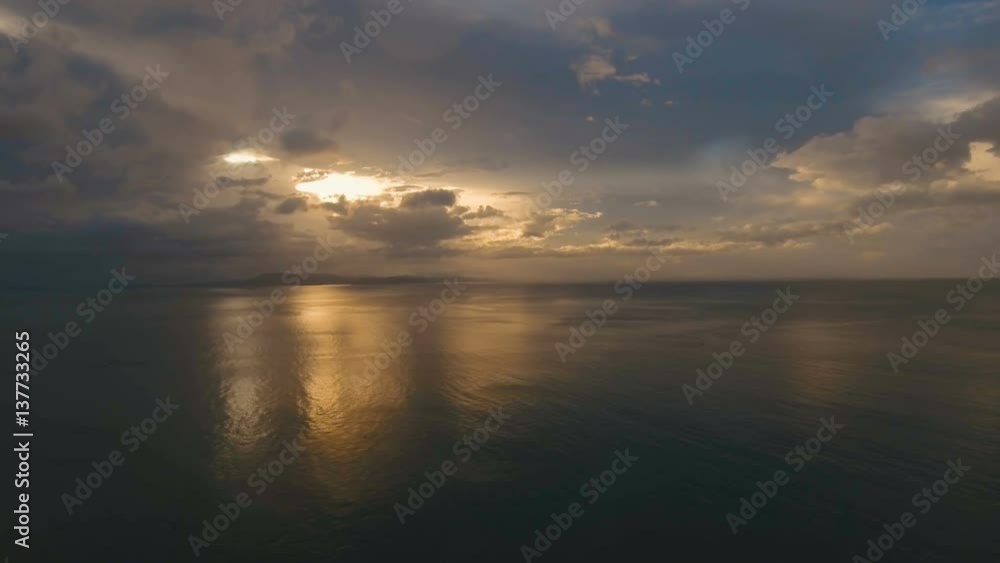 Sunset over the sea. Aerial view: Sunset over the sea in the background orange sky and islands. Fly over the ocean in sunset time. Travel concept. Nothing but sky, clouds and water. Beautiful serene Sunset over the sea. Aerial view: Sunset over the sea in the background orange sky and islands. Fly over the ocean in sunset time. Travel concept. Nothing but sky, clouds and water. Beautiful serene