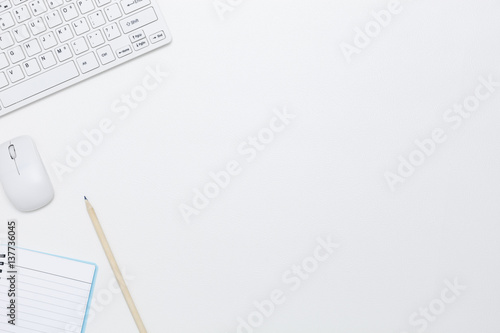 White office desk table with computer Keyboard ,notebook,mouse and pencil ,Top view with copy space for your text.