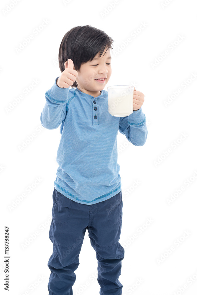 Asian boy drinking milk from a glass on white background Asian boy drinking milk from a glass on white background