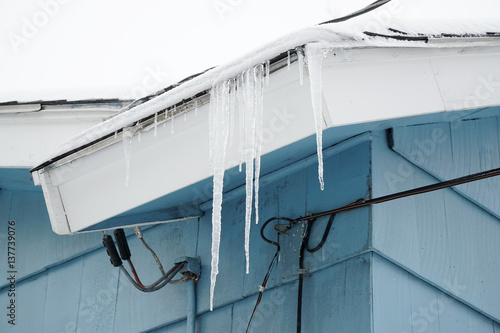 icicle from roof near power line