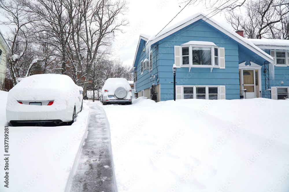 snow removal on driveway after blizzard in residential district