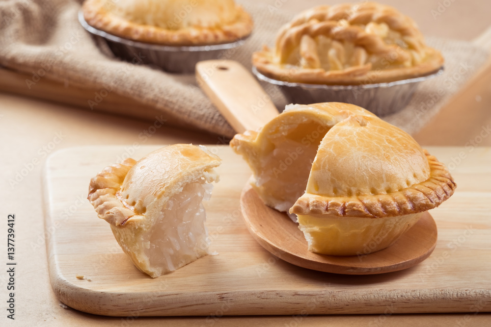 pie and tart with coconut filling on the wooden background - soft focus