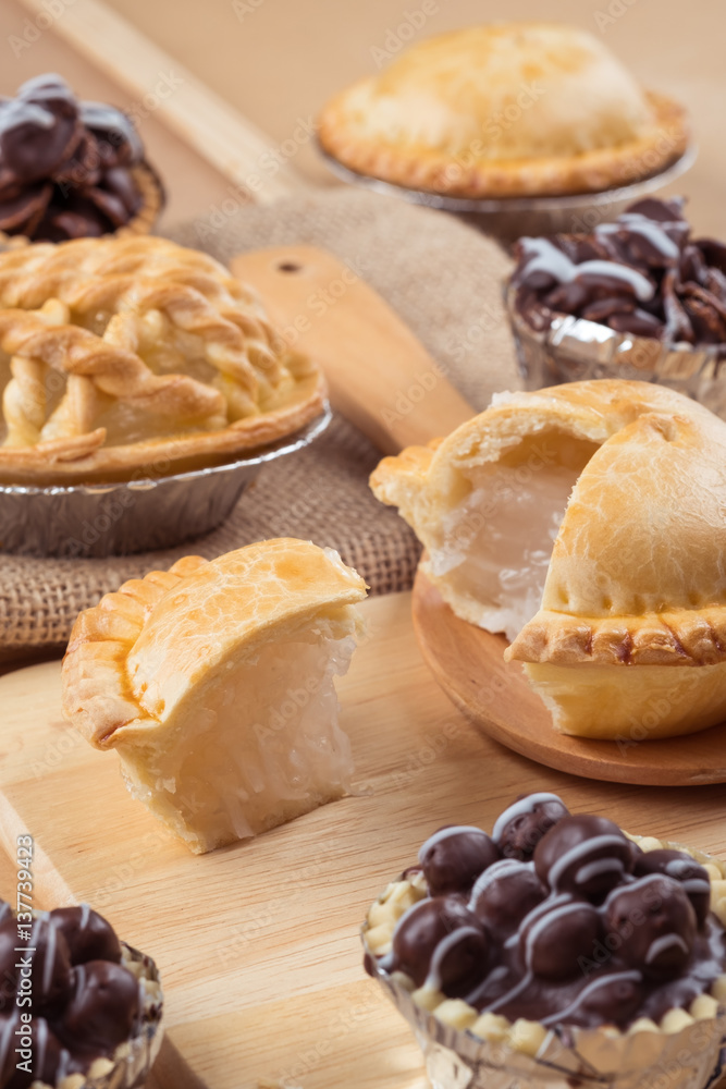 pie and tart with coconut filling on the wooden background - soft focus