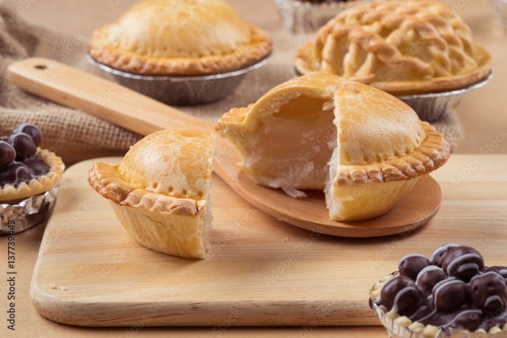 pie and tart with coconut filling on the wooden background - soft focus pie and tart with coconut filling on the wooden background - soft focus