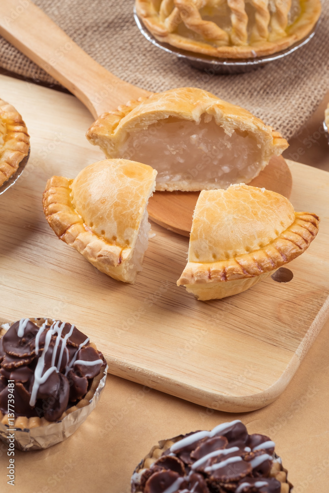 pie and tart with coconut filling on the wooden background - soft focus pie and tart with coconut filling on the wooden background - soft focus