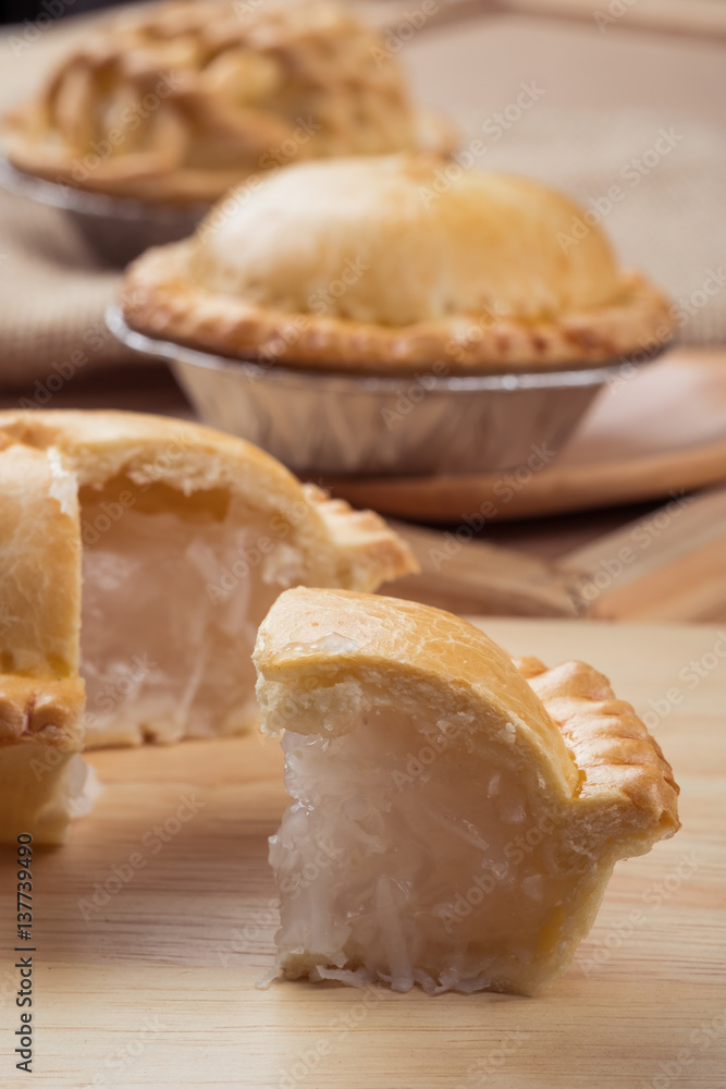 pie and tart with coconut filling on the wooden background - soft focus pie and tart with coconut filling on the wooden background - soft focus