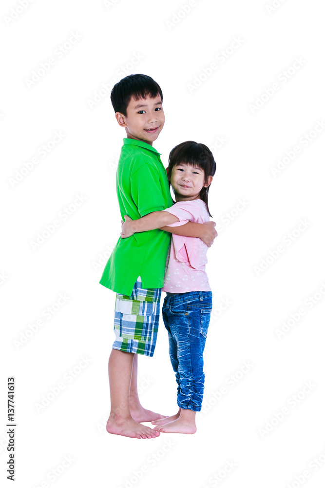 Asian kindly brother hugging his sister smiling happy together, isolated on white background. Asian kindly brother hugging his sister smiling happy together, isolated on white background.