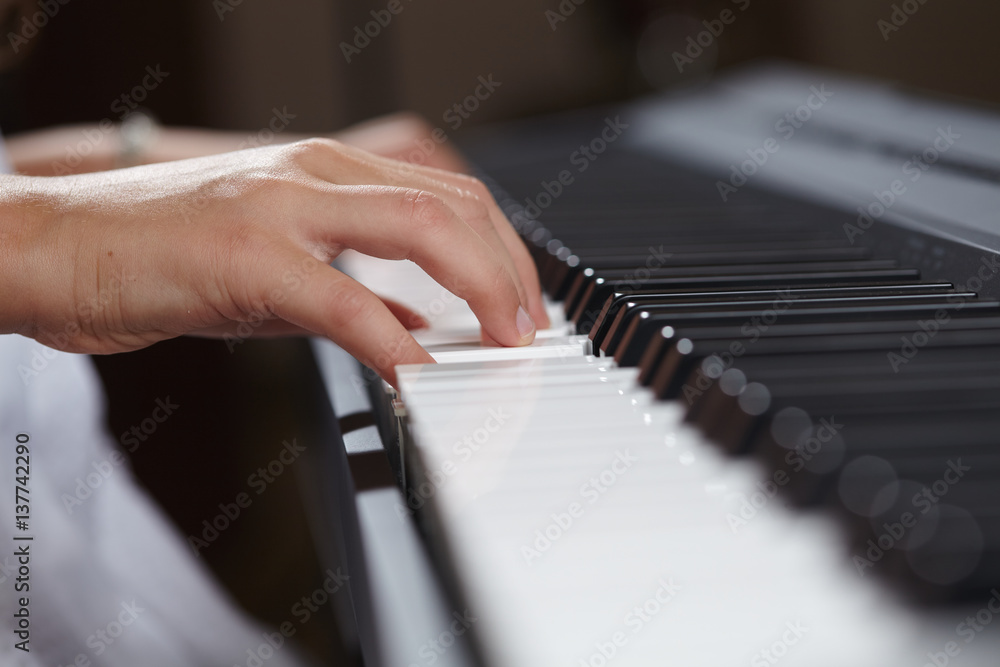 Fototapeta premium female's hands playing piano
