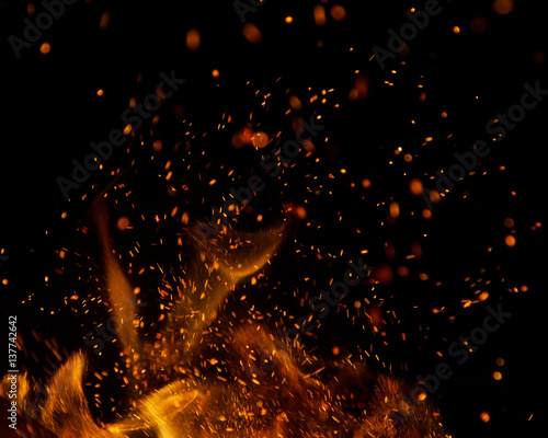 Fotografiet fire flames with sparks on a black background