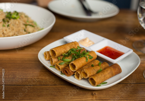Lumpia Spring Rolls on Wooden Table in Restaurant