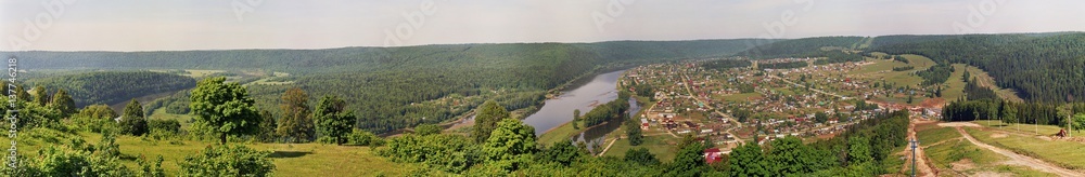 Nature panorama with a settlement in the summer