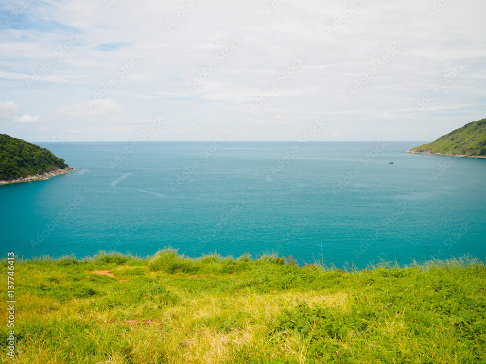 Blue sea green grass and island at Phromthep Cape phuket Thailand