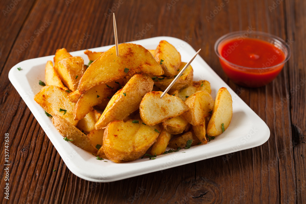 Traditional Spanish baked potato with hot pepper chili. Traditional Spanish baked potato with hot pepper chili.