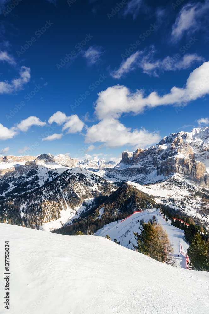 Sunny view of snow valley near Canazei of Val di Fassa, Trentino-Alto-Adige region, Italy.