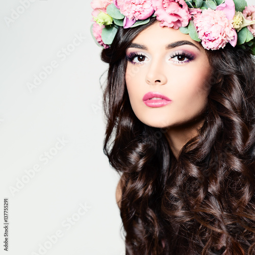 Beautiful Woman with Long Curly Hair, Perfect Makeup and Wreath of Spring Flowers