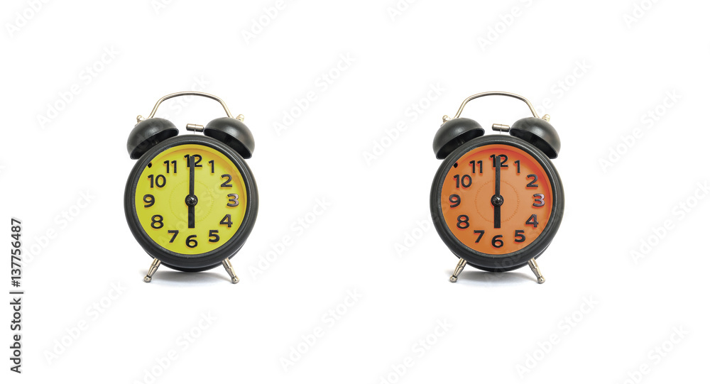 Closeup yellow alarm clock and orange alarm clock for decorate in 6 o'clock isolated on white background Closeup yellow alarm clock and orange alarm clock for decorate in 6 o'clock isolated on white background