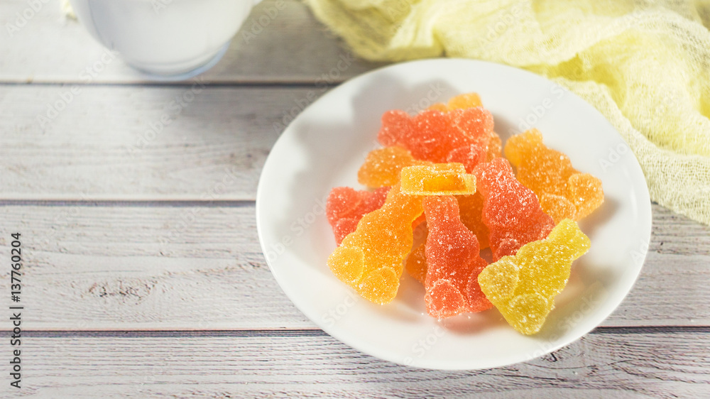 Colorful Jelly Candies Hares on white wooden table Colorful Jelly Candies Hares on white wooden table