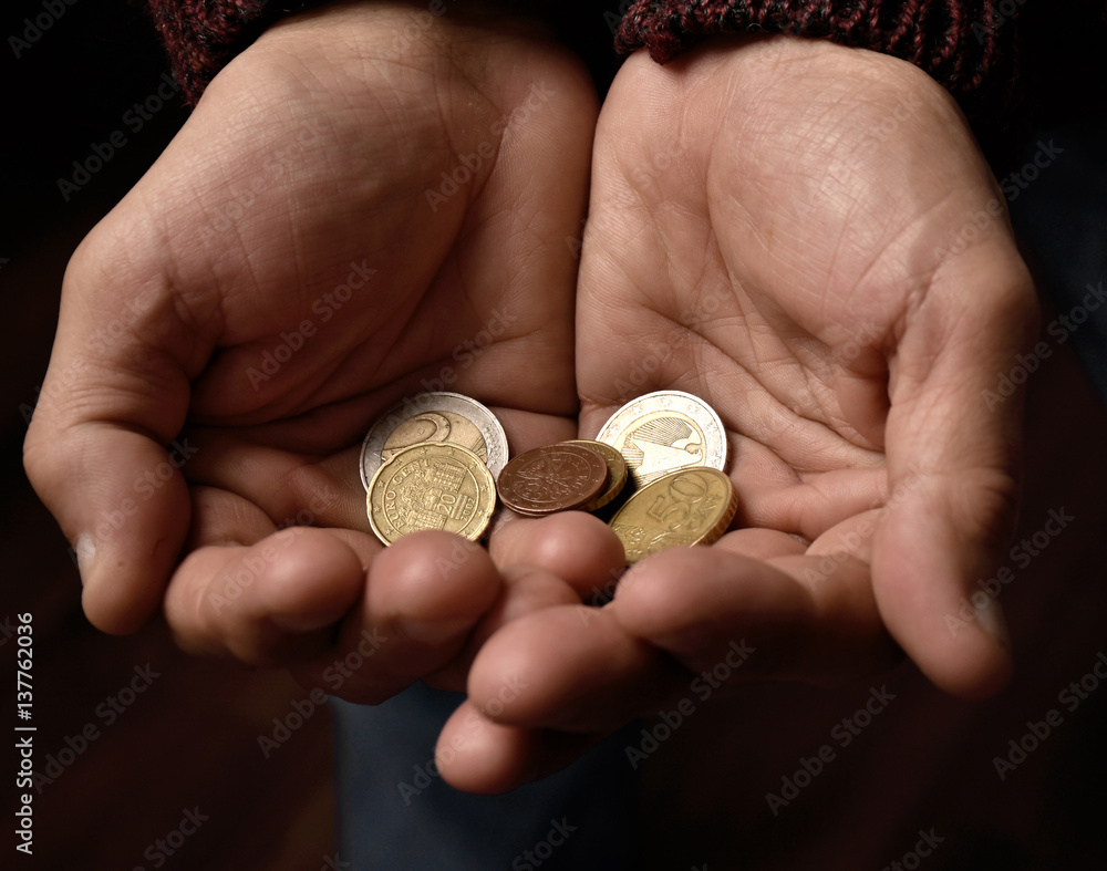 Old man holding pile of coins Old man holding pile of coins