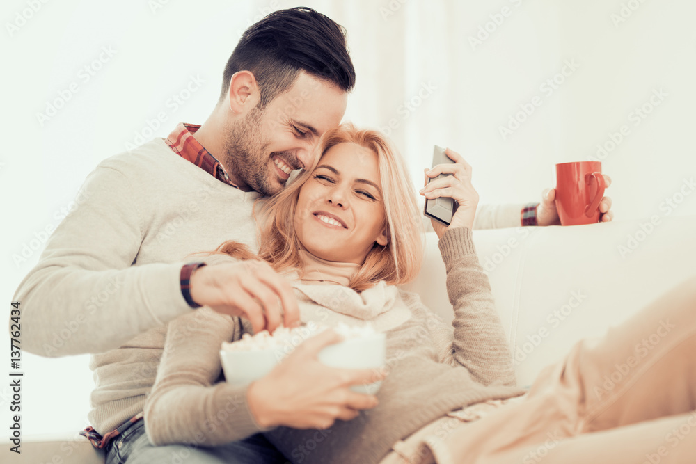 Fototapeta premium Young couple watching tv