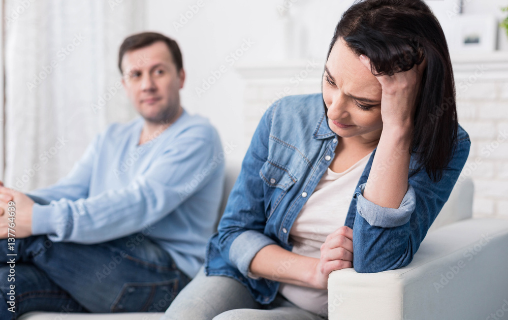 Sad depressed woman holding her forehead Sad depressed woman holding her forehead