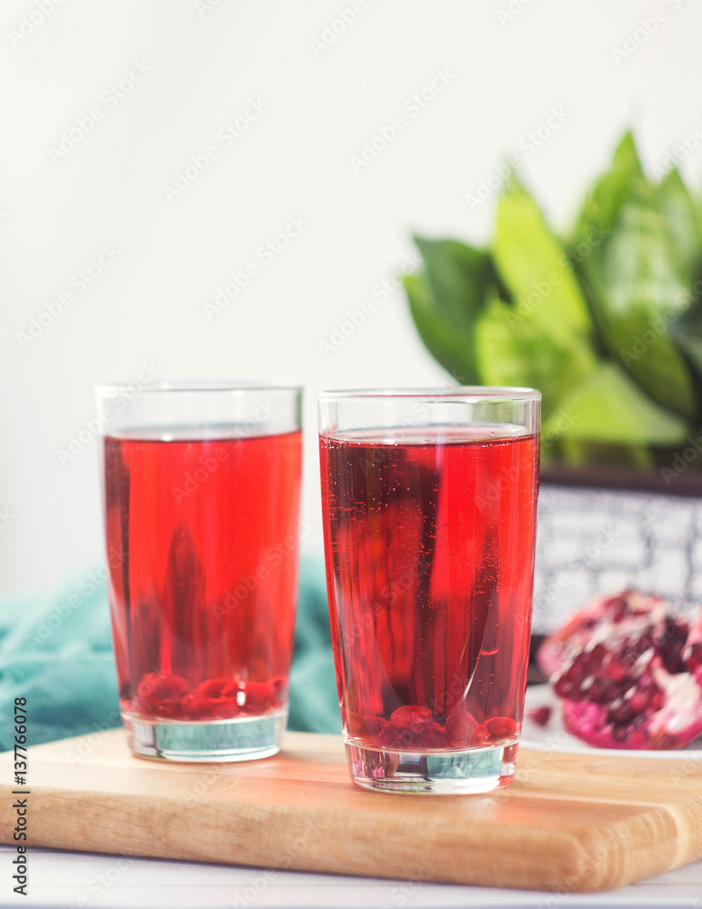 Pomegranate juice in a glass and ripe pomegranate Pomegranate juice in a glass and ripe pomegranate