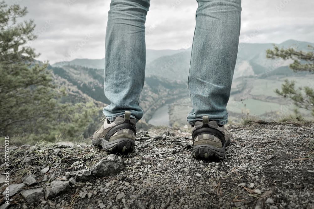 Men stay in Mountains footwear on the beautiful view. StockFoto