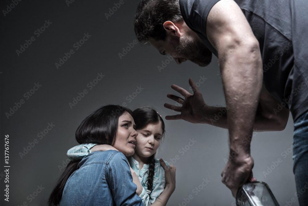 Crying young woman hugging her daughter Crying young woman hugging her daughter