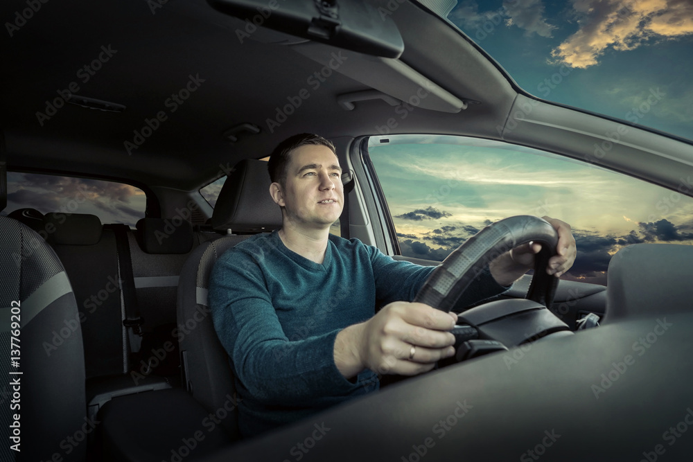 Man sitting and driving in the car.