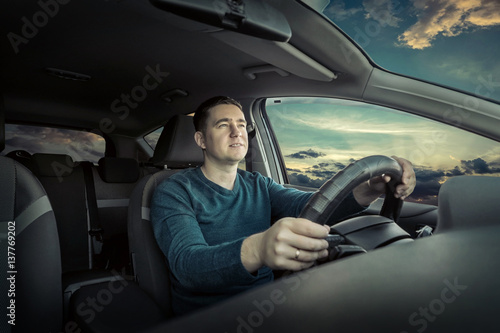 Man sitting and driving in the car. © Andrii IURLOV