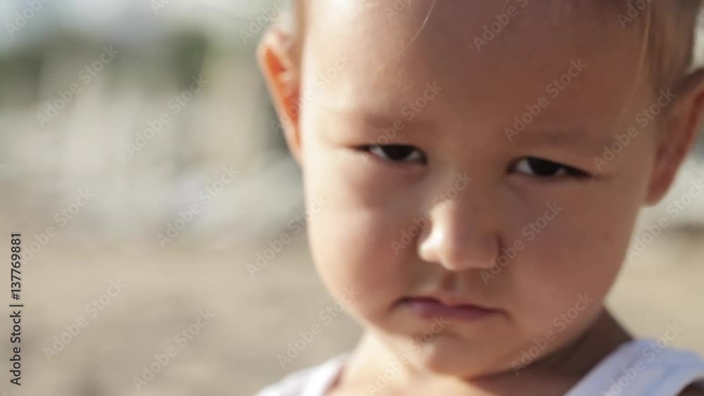 Close-up portrait of little cute girl looking at the camera with funny emotions Close-up portrait of little cute girl looking at the camera with funny emotions