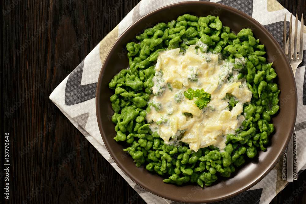 German dumplings (spaetzle) with spinach and cheese sauce. German dumplings (spaetzle) with spinach and cheese sauce.