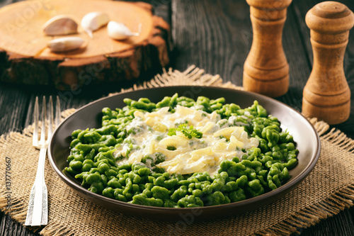 German dumplings (spaetzle) with spinach and cheese sauce. photo