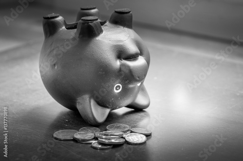 Piggy bank upside down on table, financial problems and debt concept.