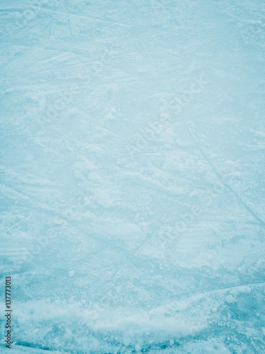 Close up photo of blue ice surface with scratches, space for texture or background