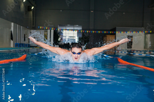 Man swimming with butterfly style in a swimming pool
