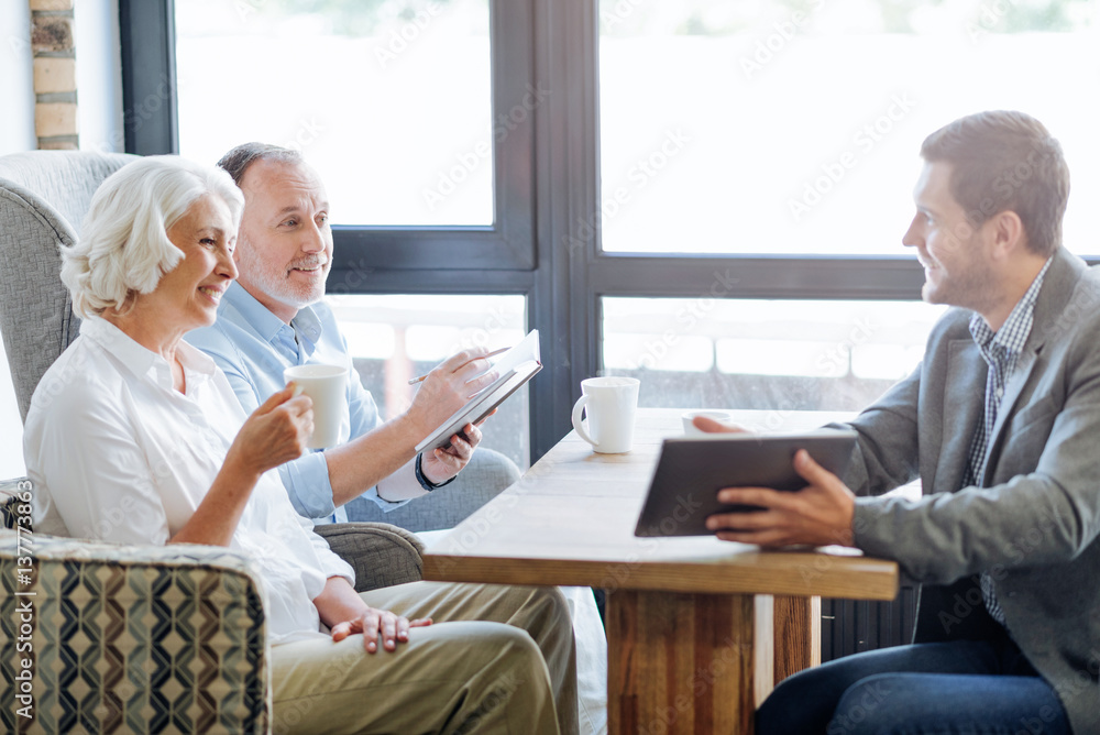 NIce smiling aged couple having meeting in the cafe NIce smiling aged couple having meeting in the cafe
