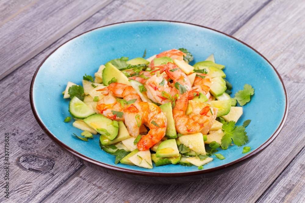 Shrimp, Avocado, Apple and Onion Salad. Grilled prawns on blue plate. Shrimp, Avocado, Apple and Onion Salad. Grilled prawns on blue plate.