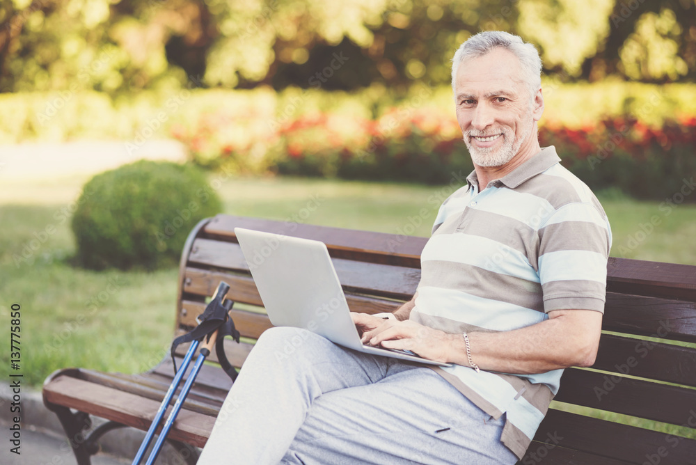 Fototapeta premium Cheerful senior man working on a laptop